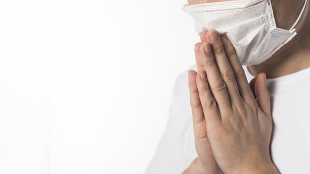 side-view-sick-patient-with-medical-mask-praying_23-2148450275